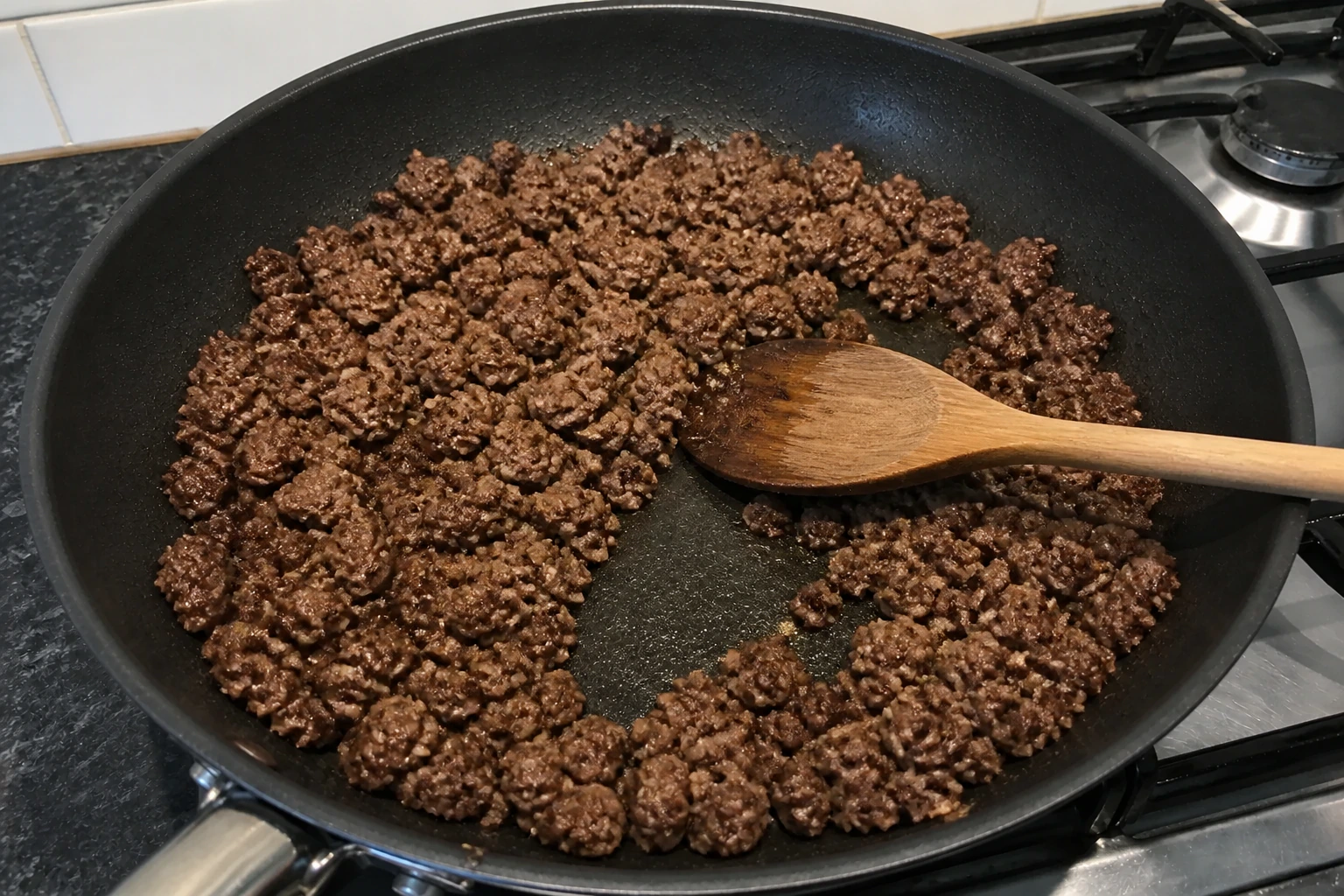 Dry browned minced beef pushed aside to reveal a pan with no released water remaining