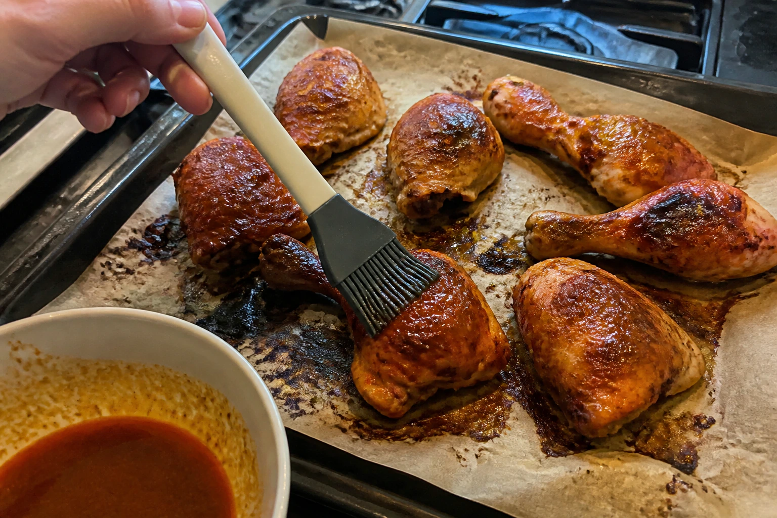 Varied bone-in peri-peri chicken pieces brushed near the end with clean reserved sauce