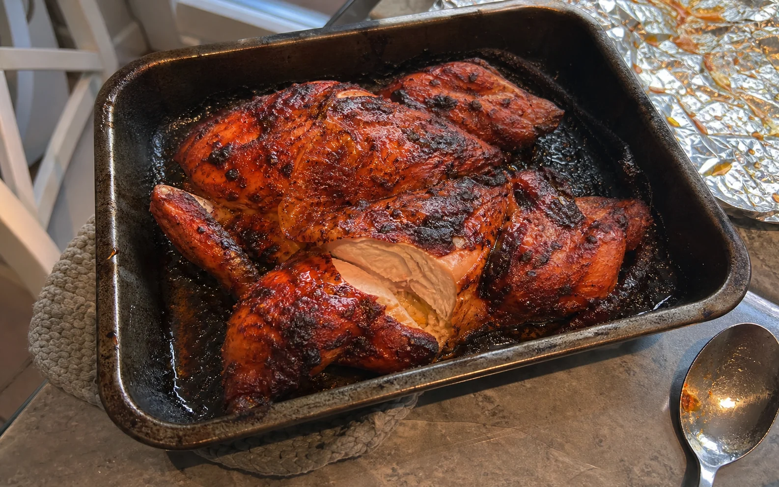 Spatchcocked tandoori-style roast chicken with charred yoghurt masala crust in its roasting tin